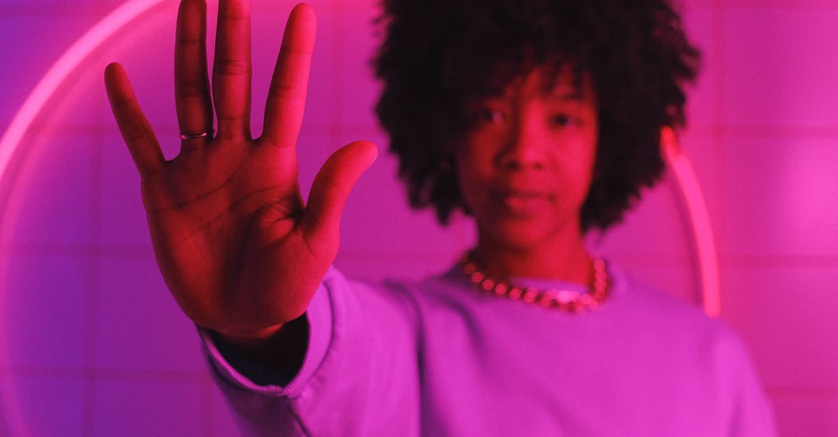 How do you stop limes from drying out? - Serious black woman standing with raised arm in room with pink illumination How do you stop limes from drying out? - Serious black woman standing with raised arm in room with pink illumination