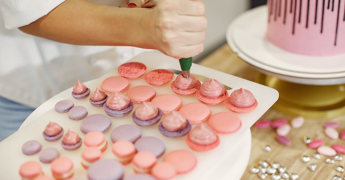How does a chocolate pudding cake work? - Crop woman making macaroons with cream in bakery How does a chocolate pudding cake work? - Crop woman making macaroons with cream in bakery
