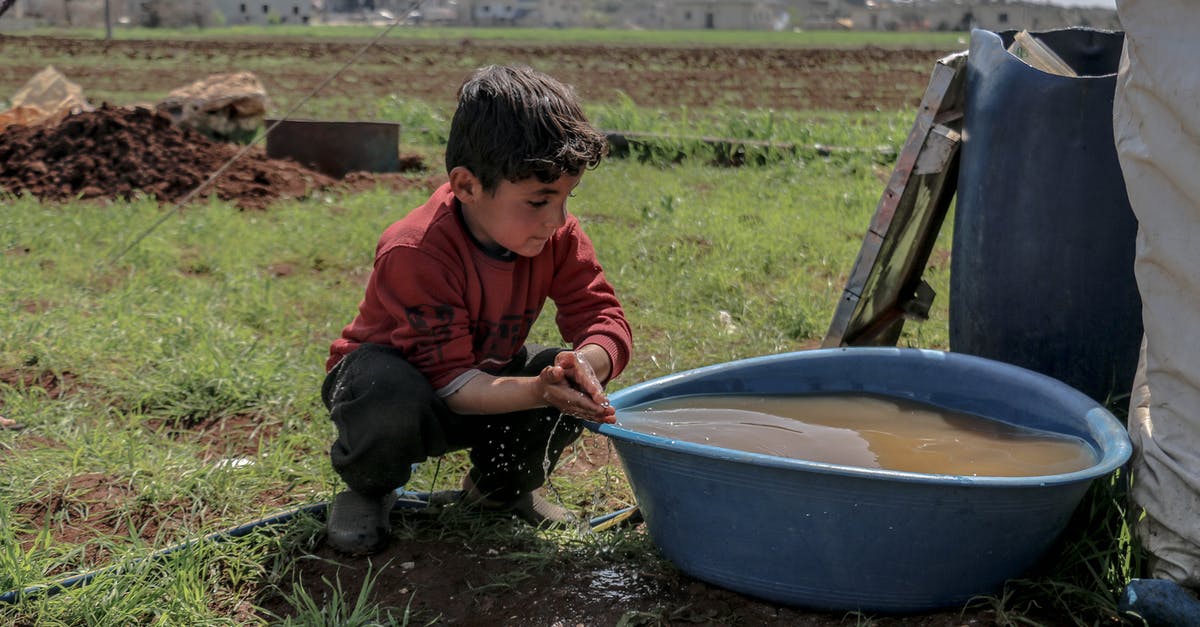How does a splash of vinegar help when poaching eggs? - Full body of cute ethnic boy washing hands in basin with water on grass in daytime How does a splash of vinegar help when poaching eggs? - Full body of cute ethnic boy washing hands in basin with water on grass in daytime