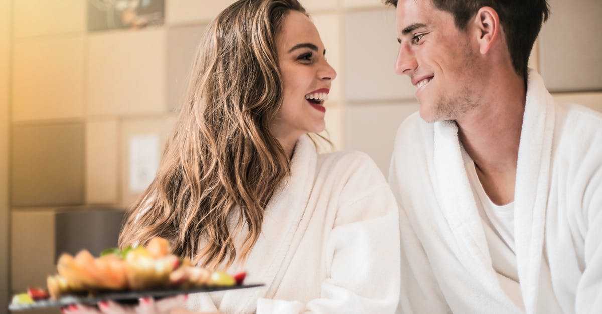 How does cooking food changes its content of carbohydrates and sugar? - Side view of content couple in bathrobes relaxing on bed with platter of mixed fruit and looking at each other How does cooking food changes its content of carbohydrates and sugar? - Side view of content couple in bathrobes relaxing on bed with platter of mixed fruit and looking at each other