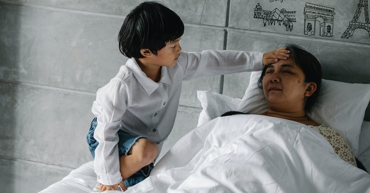 How does core temperature relate with slow cooking? - Little Asian boy measuring temperature of sleeping grandmother How does core temperature relate with slow cooking? - Little Asian boy measuring temperature of sleeping grandmother