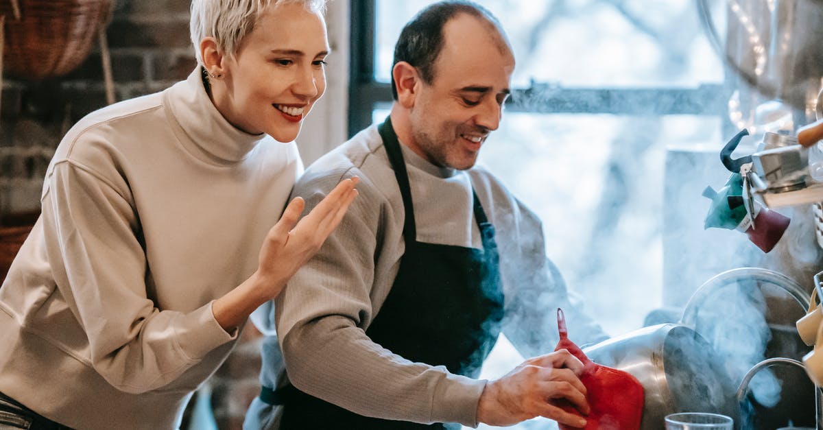 How does double-bagging sous vide food affect cook time? - Happy ethnic man preparing dinner for smiling wife in kitchen How does double-bagging sous vide food affect cook time? - Happy ethnic man preparing dinner for smiling wife in kitchen