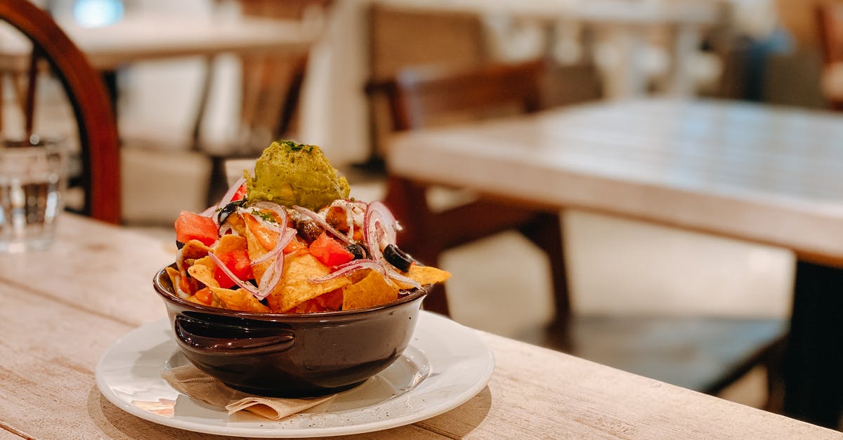 How does pepper enhance/increase the saltiness of a dish? - Tasty fresh nachos with guacamole in bowl on wooden table in Mexican restaurant How does pepper enhance/increase the saltiness of a dish? - Tasty fresh nachos with guacamole in bowl on wooden table in Mexican restaurant