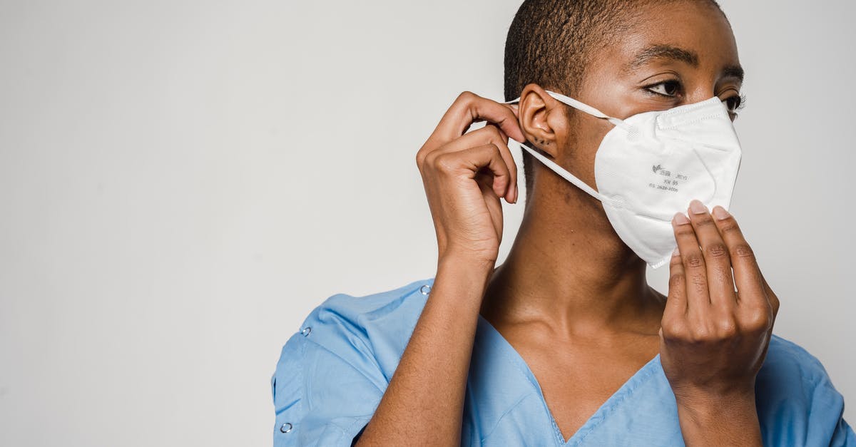 How does removing the germ of garlic help with breath/digestion? - African American female doctor putting on protective mask How does removing the germ of garlic help with breath/digestion? - African American female doctor putting on protective mask