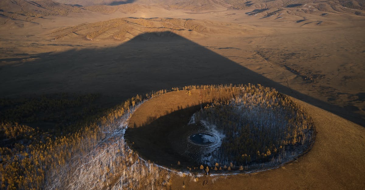 How does sourdough (wild yeast) starter differ from location to location? - Aerial view of Khorgo extinct volcano grown with forest and covered with snow casting huge dark shadow on valley in national park in Mongolia How does sourdough (wild yeast) starter differ from location to location? - Aerial view of Khorgo extinct volcano grown with forest and covered with snow casting huge dark shadow on valley in national park in Mongolia