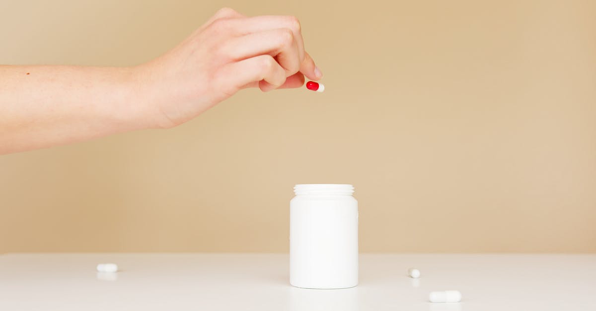 How does vacuum sealing something in a mason jar help? - Crop woman putting scattered pills back in jar How does vacuum sealing something in a mason jar help? - Crop woman putting scattered pills back in jar