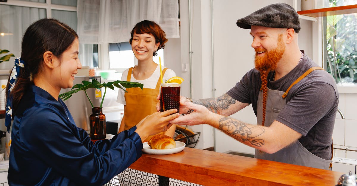How does velveting work? - Glad hipster male employee passing glass of Black Velvet cocktail to smiling ethnic colleague at work How does velveting work? - Glad hipster male employee passing glass of Black Velvet cocktail to smiling ethnic colleague at work