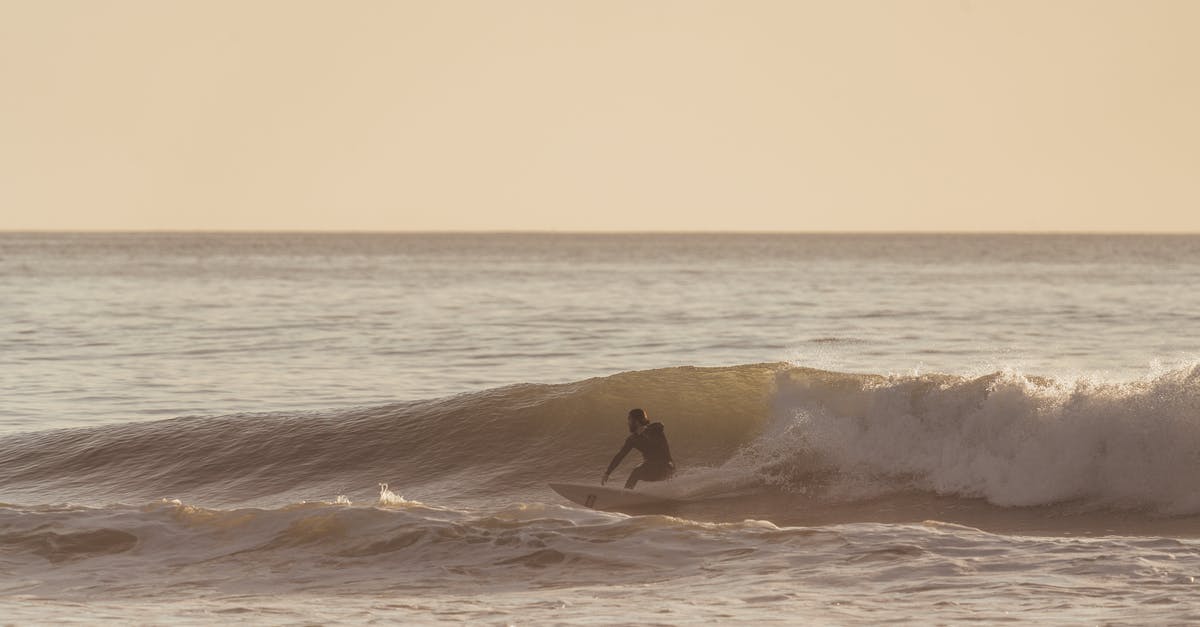 How fast does water cool off after boiling? - Man riding wave on surfboard under cloudy sky How fast does water cool off after boiling? - Man riding wave on surfboard under cloudy sky