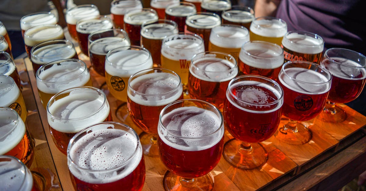 How is beer classified into different types? - Anonymous man tasting various types of beer in outdoor bar How is beer classified into different types? - Anonymous man tasting various types of beer in outdoor bar