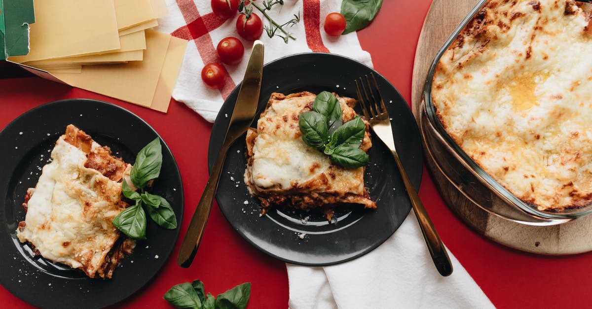 How is this lasagna pasta supposed to be cooked? - Two Servings Of Lasagna On Black Plates How is this lasagna pasta supposed to be cooked? - Two Servings Of Lasagna On Black Plates