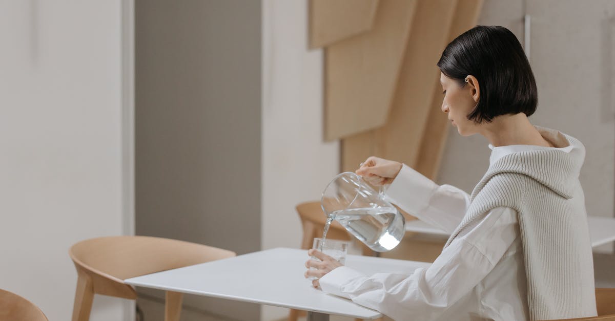 How long can a pitcher of tap water be left out, and still be drinkable? - Woman in White Long Sleeve Shirt Sitting on White Chair How long can a pitcher of tap water be left out, and still be drinkable? - Woman in White Long Sleeve Shirt Sitting on White Chair