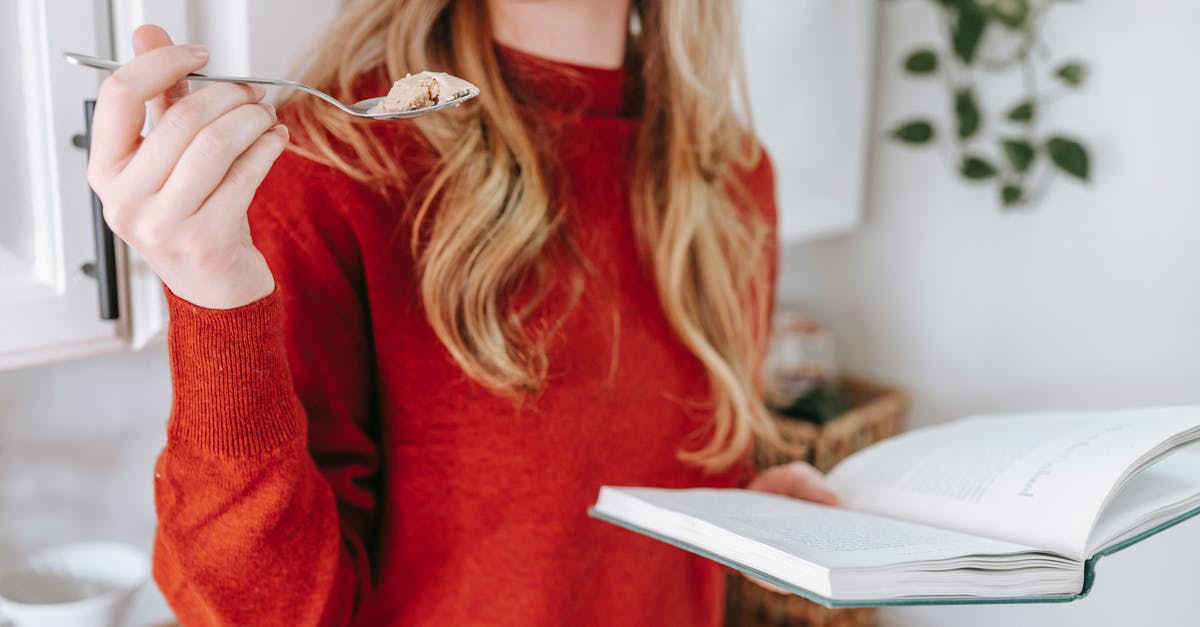 How long does an opened and unrefrigerated tub of yogurt last? [duplicate] - Crop anonymous lady with long wavy blond hair in red sweater eating delicious yogurt while reading interesting book in light kitchen