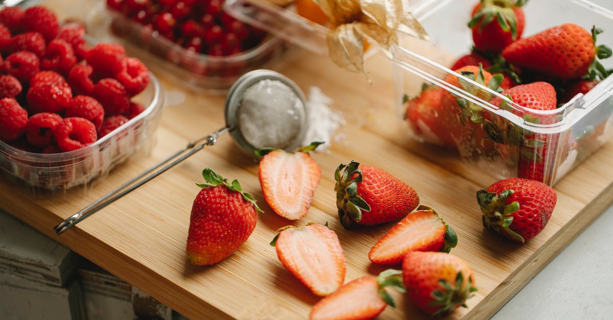 How long should I cook a half goose? - Halves and whole strawberries with raspberries and physalis in plastic containers placed on wooden board
