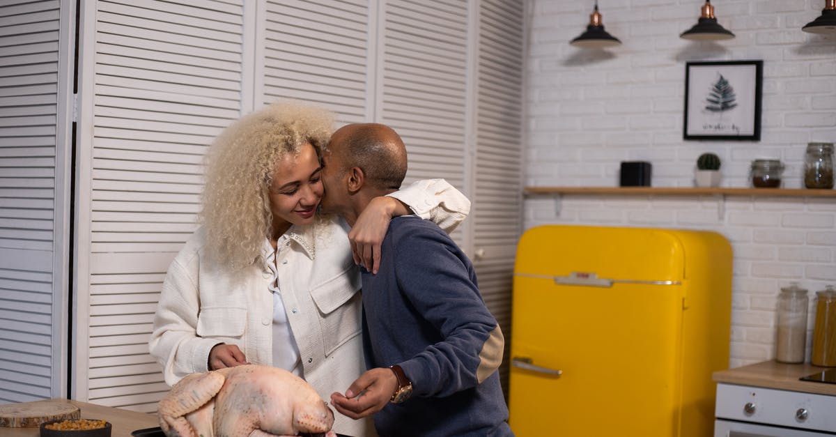 How long will a whole turkey keep in a refrigerator? - Tender African American husband kissing positive black wife with closed eyes while standing near counter with uncooked turkey during cooking in modern kitchen How long will a whole turkey keep in a refrigerator? - Tender African American husband kissing positive black wife with closed eyes while standing near counter with uncooked turkey during cooking in modern kitchen