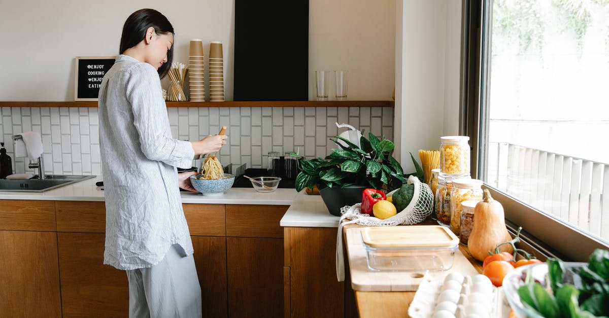 How long will homemade salad dressing stay good in the fridge? - Side view of young Asian female with long dark hair in comfy clothes preparing noodles while standing at counter with assorted fresh products in kitchen How long will homemade salad dressing stay good in the fridge? - Side view of young Asian female with long dark hair in comfy clothes preparing noodles while standing at counter with assorted fresh products in kitchen