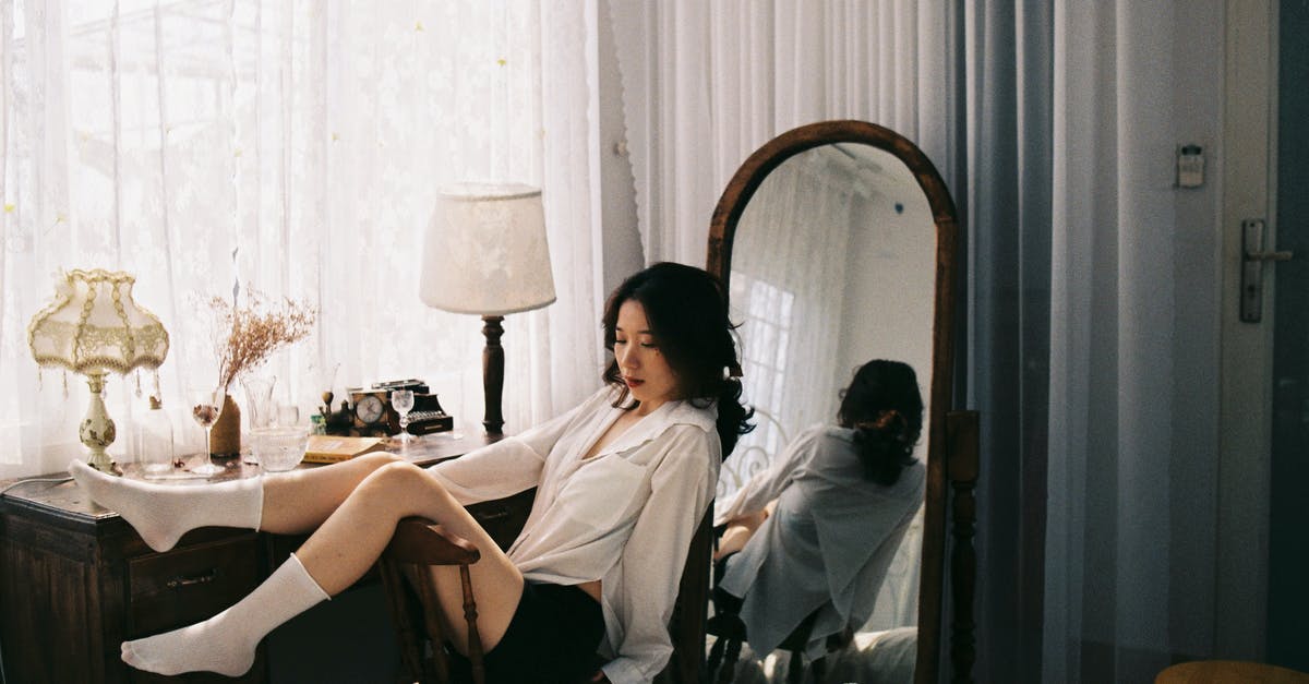 How long would you keep this Caesar dressing? - Brunette Woman in Bedroom Sitting in Chair with Legs on Backrest