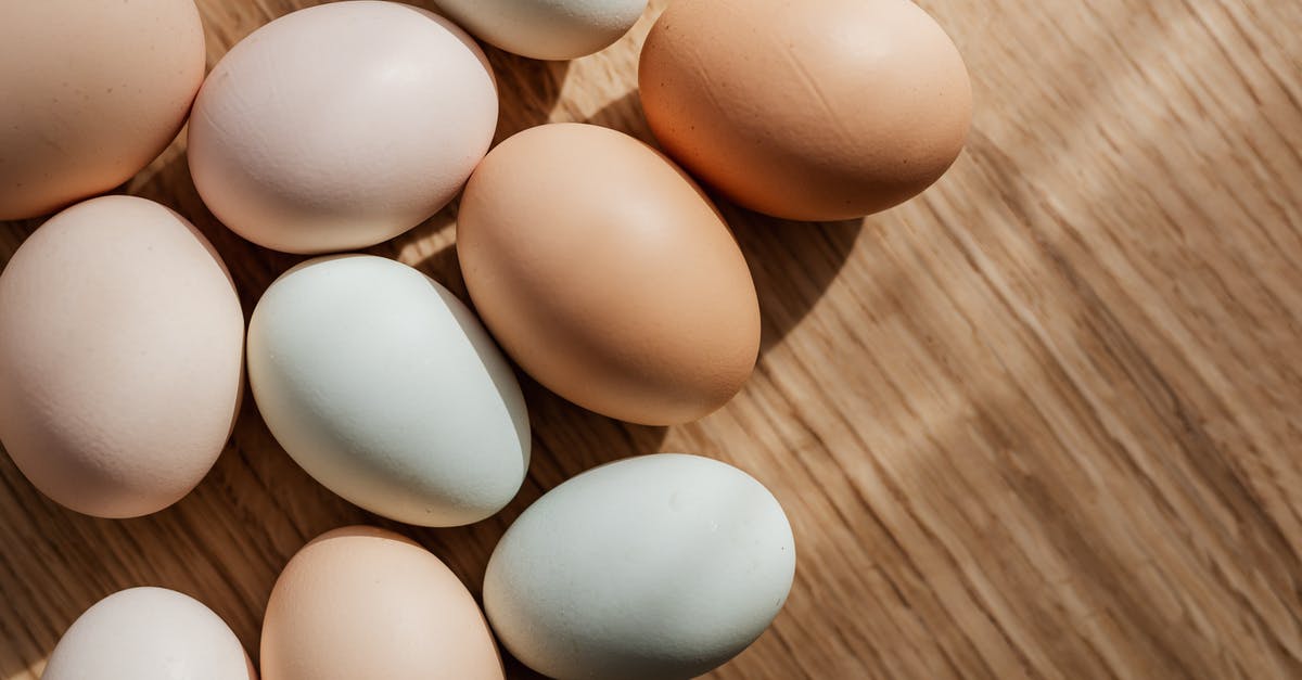 How many times can you reheat boiled eggs? - Top view of assorted mixed chicken raw multicolored eggs placed together on wooden surface during daytime How many times can you reheat boiled eggs? - Top view of assorted mixed chicken raw multicolored eggs placed together on wooden surface during daytime