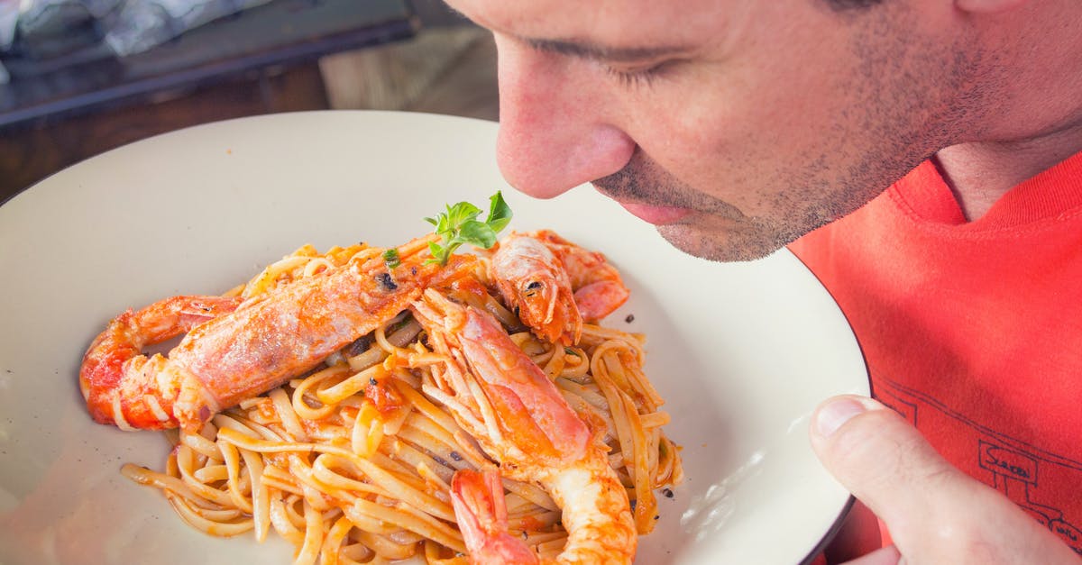 How much beef and seafood should I buy for mixed 12 adult dinner party? - Man Smelling Prawn and Pasta Dish on White Ceramic Plate How much beef and seafood should I buy for mixed 12 adult dinner party? - Man Smelling Prawn and Pasta Dish on White Ceramic Plate