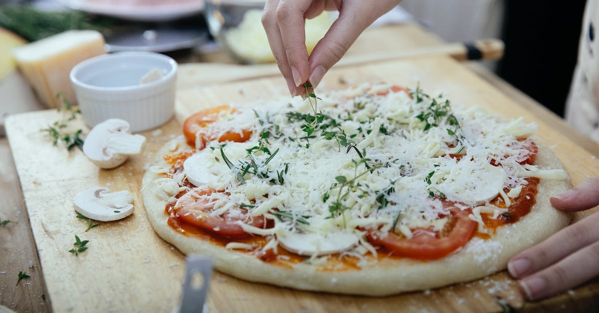 How much foreign substance can I add to processed cheese? - Crop woman adding herbs on pizza How much foreign substance can I add to processed cheese? - Crop woman adding herbs on pizza