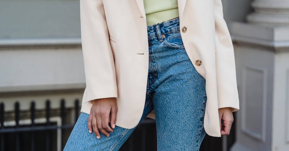 How much is a sleeve of celery? - Crop anonymous trendy female in beige jacket and jeans standing in town in daylight How much is a sleeve of celery? - Crop anonymous trendy female in beige jacket and jeans standing in town in daylight