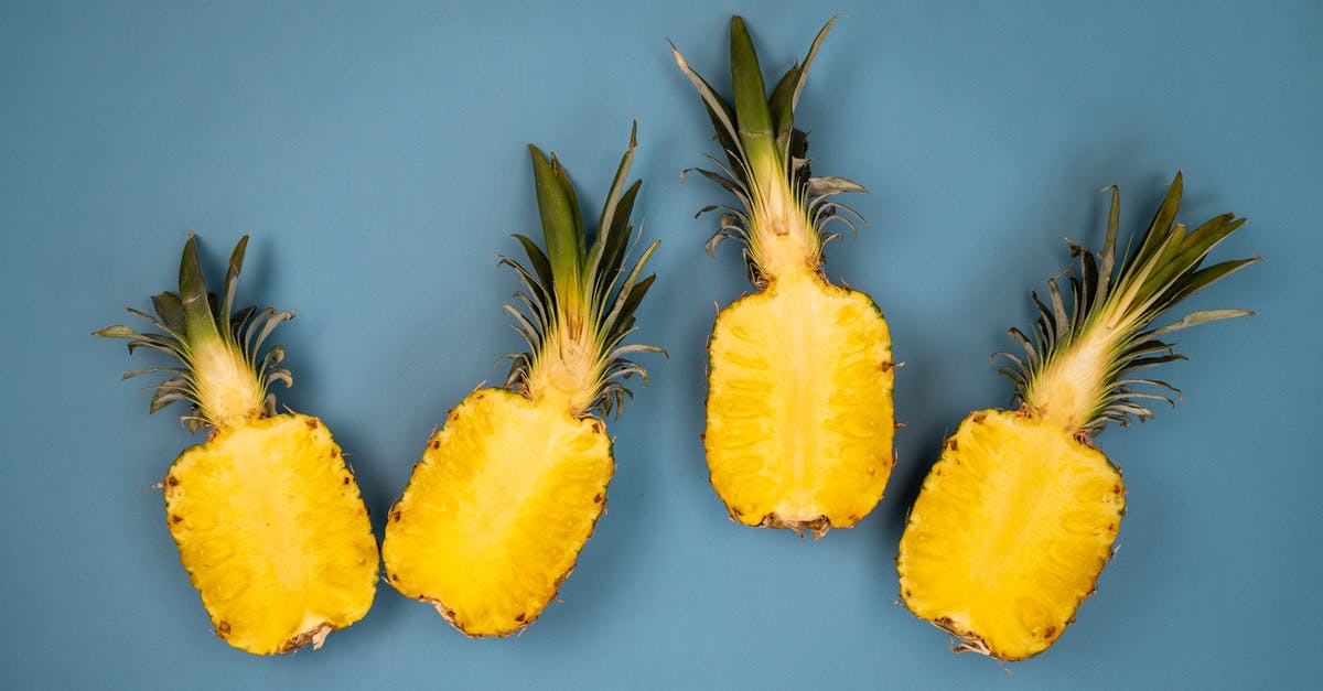 How much juice is in a pineapple - Delicious pineapple on blue surface How much juice is in a pineapple - Delicious pineapple on blue surface