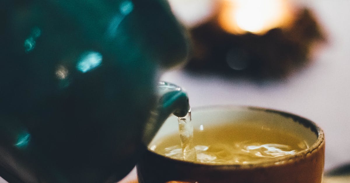 How much liquid jaggery equals 1 cup jaggery powder? - Person Pouring Liquid Into Brown Ceramic Cup How much liquid jaggery equals 1 cup jaggery powder? - Person Pouring Liquid Into Brown Ceramic Cup