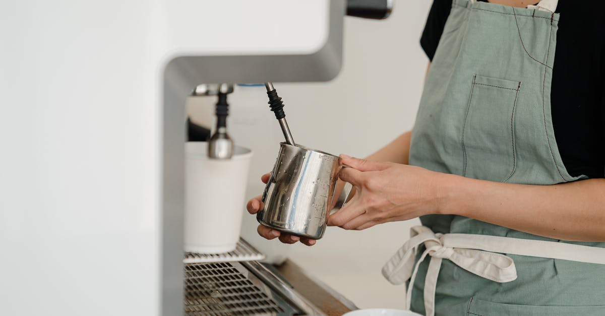 How much milk do I need to make 100 g Paneer? - Crop coffee house worker making coffee using coffee machine How much milk do I need to make 100 g Paneer? - Crop coffee house worker making coffee using coffee machine