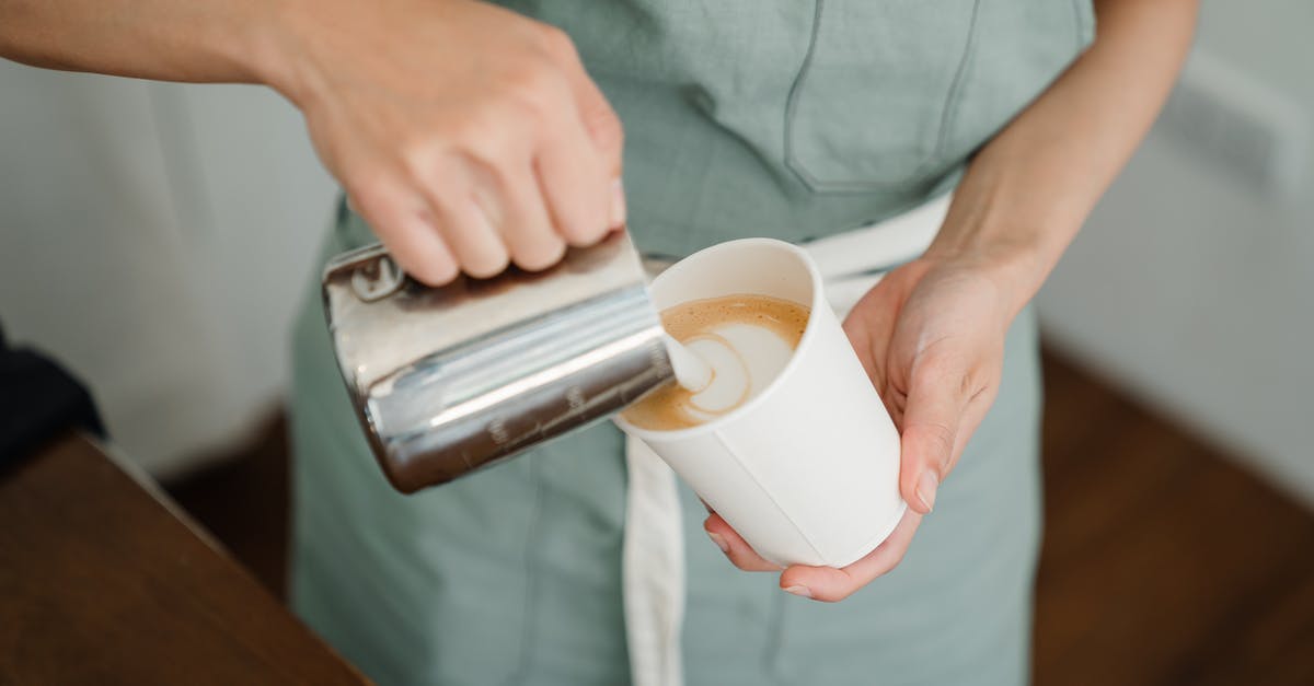 How much milk do I need to make 100 g Paneer? - Crop barista pouring milk froth in cappuccino for client How much milk do I need to make 100 g Paneer? - Crop barista pouring milk froth in cappuccino for client