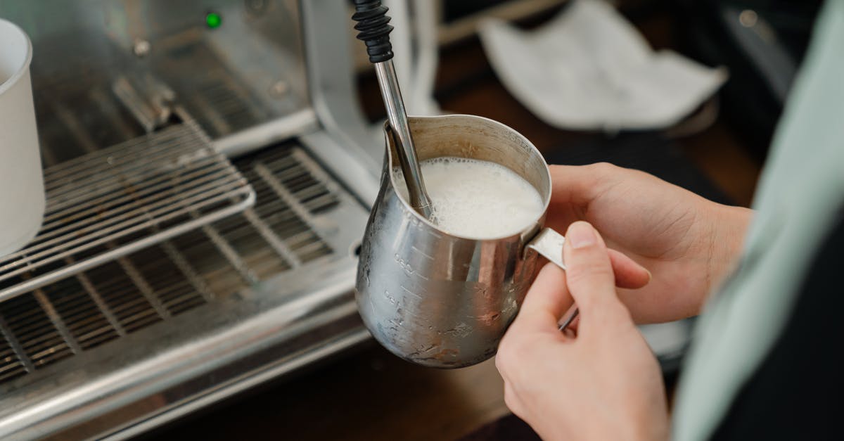 How much milk do I need to make 100 g Paneer? - Crop barista whipping milk in stainless steel cup How much milk do I need to make 100 g Paneer? - Crop barista whipping milk in stainless steel cup