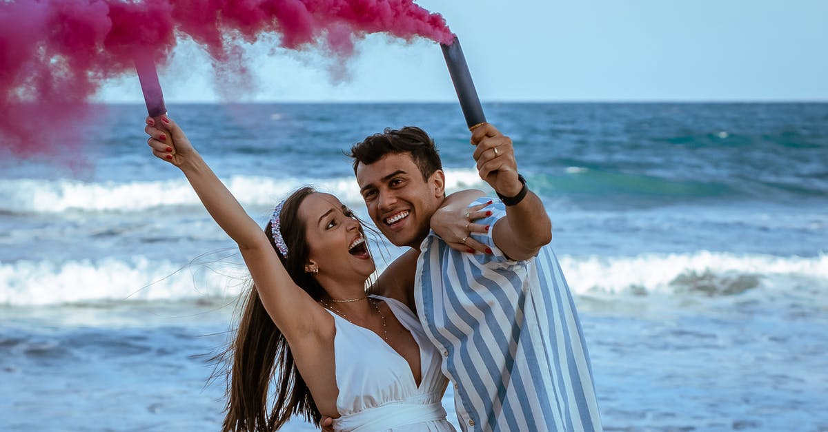 How much smoke to expect from making a roux? - Cheerful pregnant couple in trendy apparels holding bomb of pink colorful smoke embracing near wavy ocean How much smoke to expect from making a roux? - Cheerful pregnant couple in trendy apparels holding bomb of pink colorful smoke embracing near wavy ocean