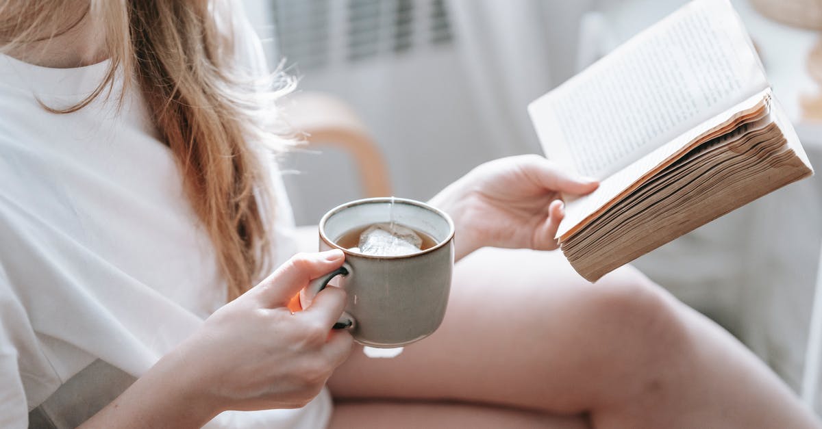 How much tea is ideal out of one tea bag? - Crop anonymous female with crossed legs and cup of hot drink reading aged textbook in armchair at home How much tea is ideal out of one tea bag? - Crop anonymous female with crossed legs and cup of hot drink reading aged textbook in armchair at home