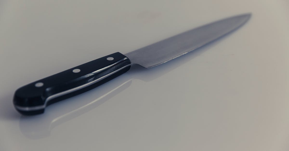How sharp should a paring knife be? - Black Handle Knife on White Table How sharp should a paring knife be? - Black Handle Knife on White Table