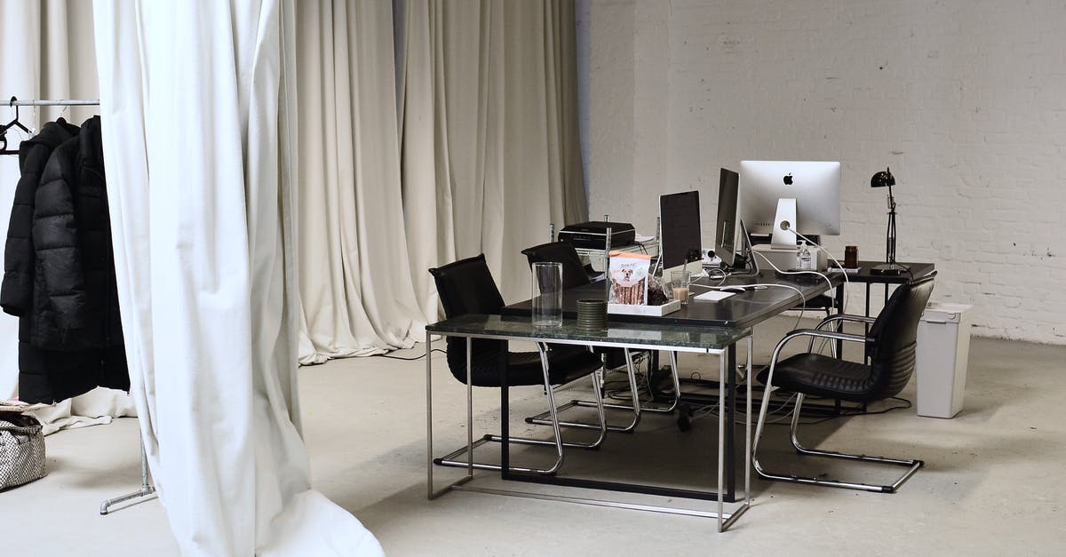 How should I manage my fridge? - Interior of conference room with modern personal computers placed on table with clothes hanging on rail How should I manage my fridge? - Interior of conference room with modern personal computers placed on table with clothes hanging on rail