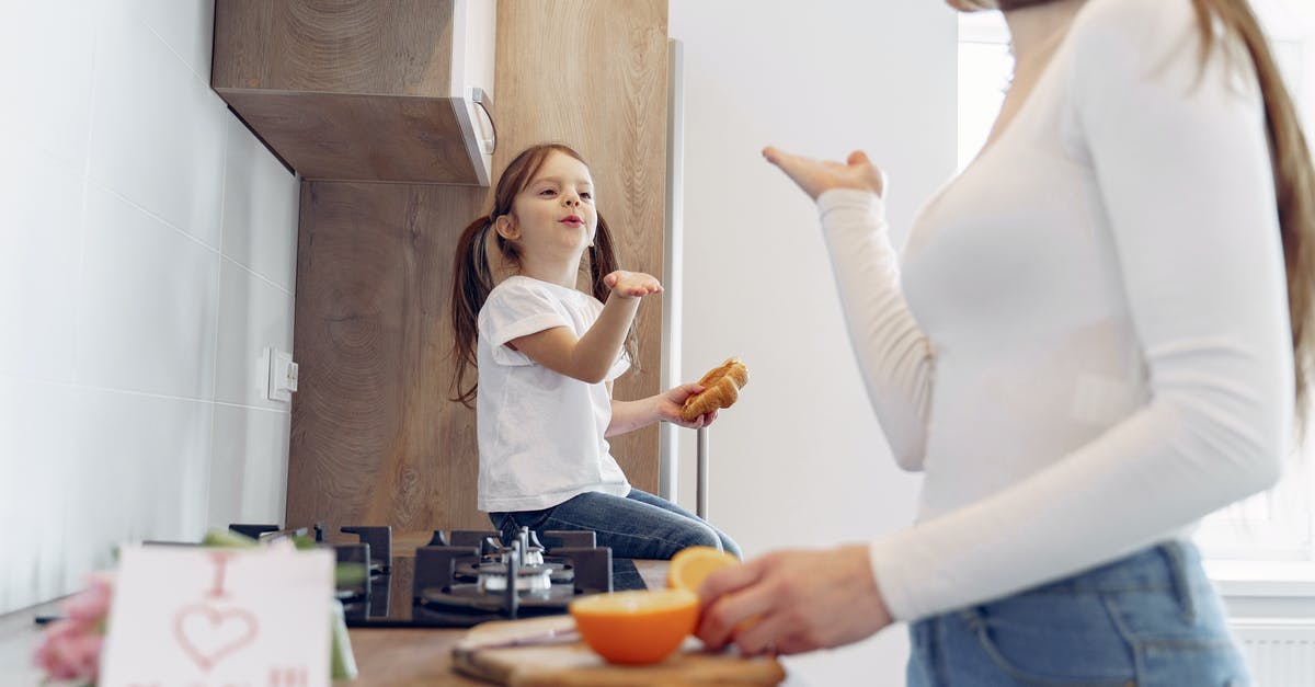 How should I prepare Risotto - Loving mother and daughter blowing kiss on kitchen How should I prepare Risotto - Loving mother and daughter blowing kiss on kitchen