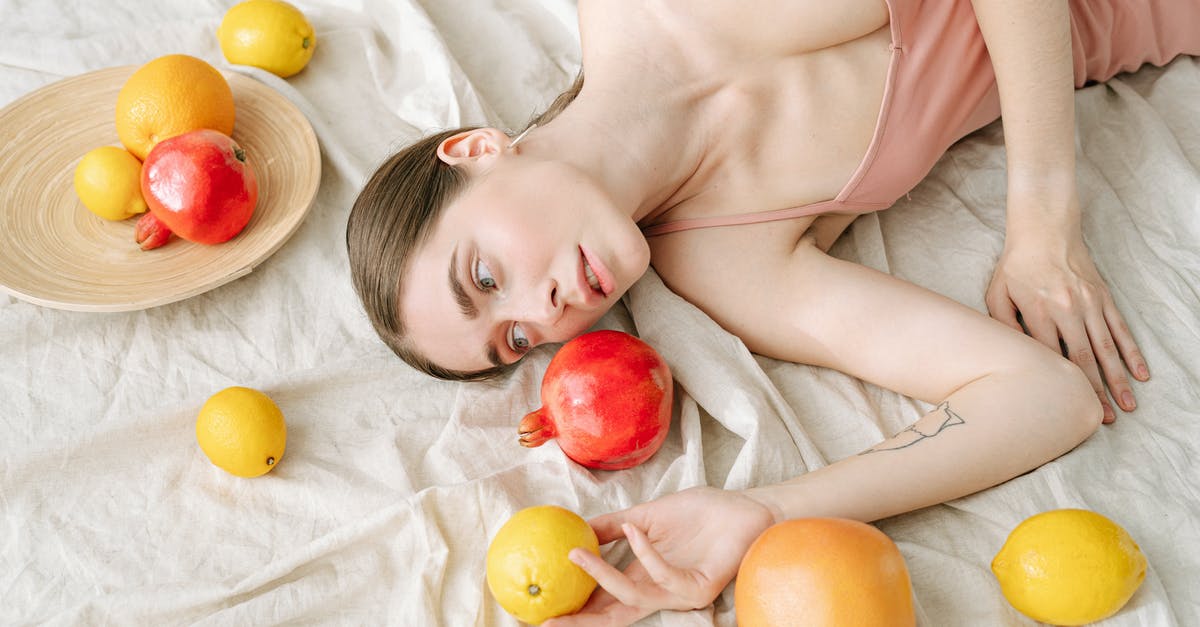 How should pomegranates be stored? - Woman in Pink Spaghetti Strap Dress Lying on White Linen Beside Fruits How should pomegranates be stored? - Woman in Pink Spaghetti Strap Dress Lying on White Linen Beside Fruits