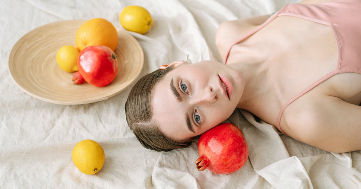 How should pomegranates be stored? - Woman Lying on White Linen Beside Fruits How should pomegranates be stored? - Woman Lying on White Linen Beside Fruits
