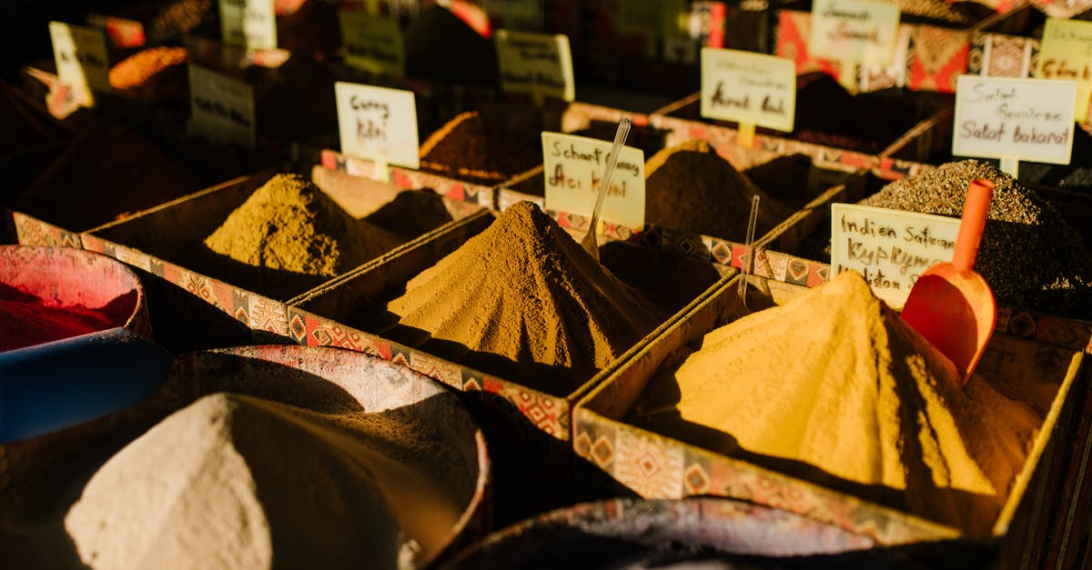 How spicy is authentic, traditional Palak paneer? - Traditional market stall with various aromatic spices