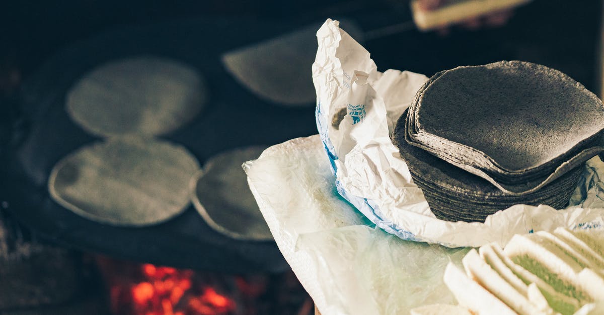 How to 'bread' with corn - High angle of crop anonymous cook frying Mexican blue tortilla on fireplace near table with homemade cheese How to 'bread' with corn - High angle of crop anonymous cook frying Mexican blue tortilla on fireplace near table with homemade cheese