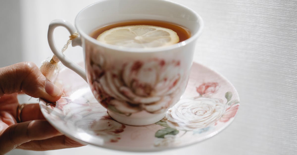 How to add lemon flavor to tea? - Hand of crop anonymous person holding elegant saucer with cup of hot aromatic tea with slice of lemon How to add lemon flavor to tea? - Hand of crop anonymous person holding elegant saucer with cup of hot aromatic tea with slice of lemon