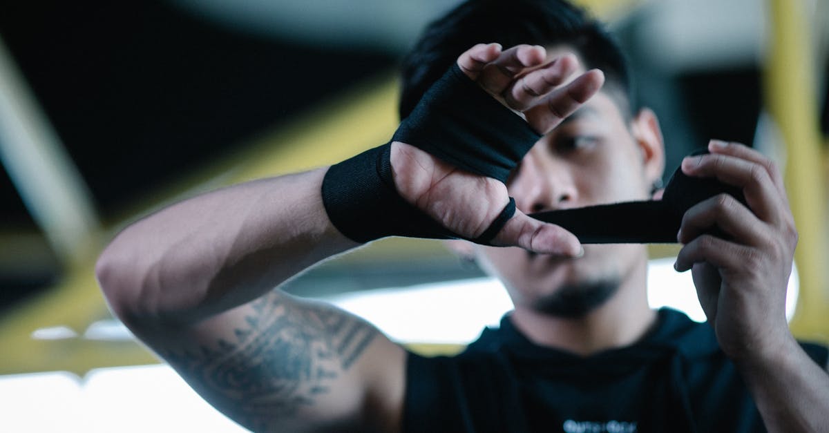 How to adjust refrigerator temperature/power? - Male Asian athlete bandaging hands with elastic dark wraps before boxing workout in gym How to adjust refrigerator temperature/power? - Male Asian athlete bandaging hands with elastic dark wraps before boxing workout in gym