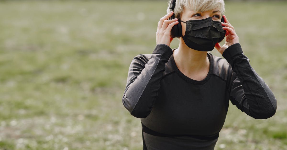 How to adjust refrigerator temperature/power? - Young female in sportswear with black protective mask looking away and adjusting headphones while having rest after working out in park How to adjust refrigerator temperature/power? - Young female in sportswear with black protective mask looking away and adjusting headphones while having rest after working out in park