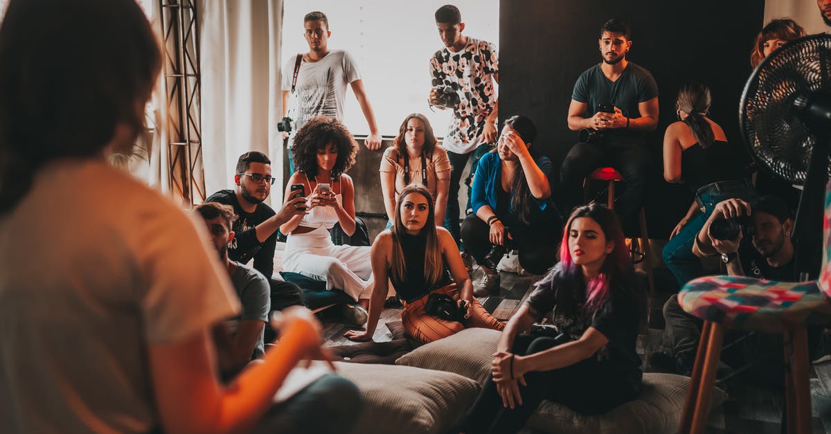 How to assemble a springform pan? - Group of multiethnic people gathering around female speaker in studio How to assemble a springform pan? - Group of multiethnic people gathering around female speaker in studio