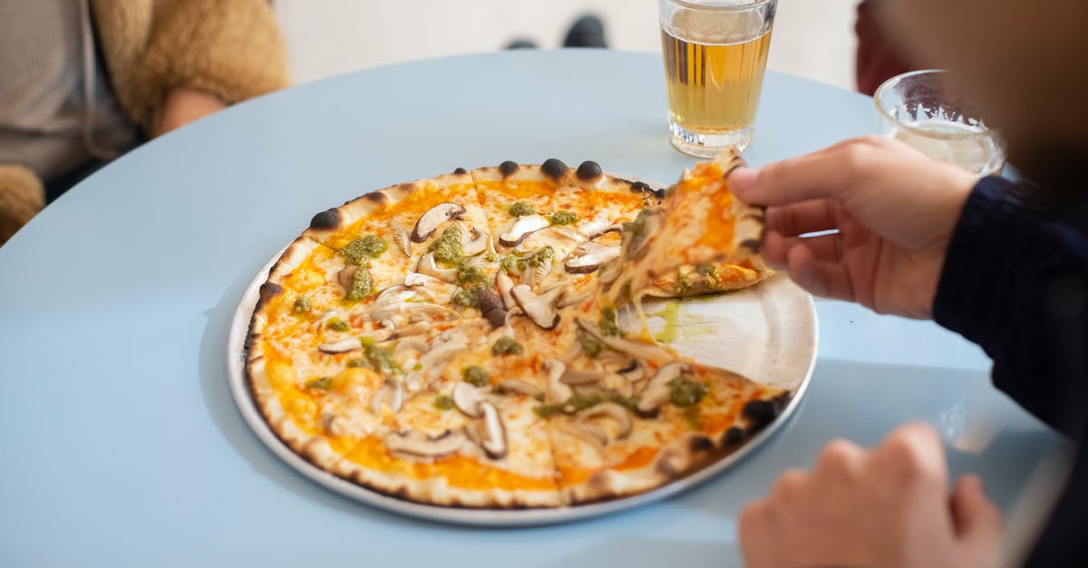 How to avoid herbs getting burnt in the oven - A Person in Black Long Sleeve Shirt Holding a Slice of Pizza on a Round Tray How to avoid herbs getting burnt in the oven - A Person in Black Long Sleeve Shirt Holding a Slice of Pizza on a Round Tray