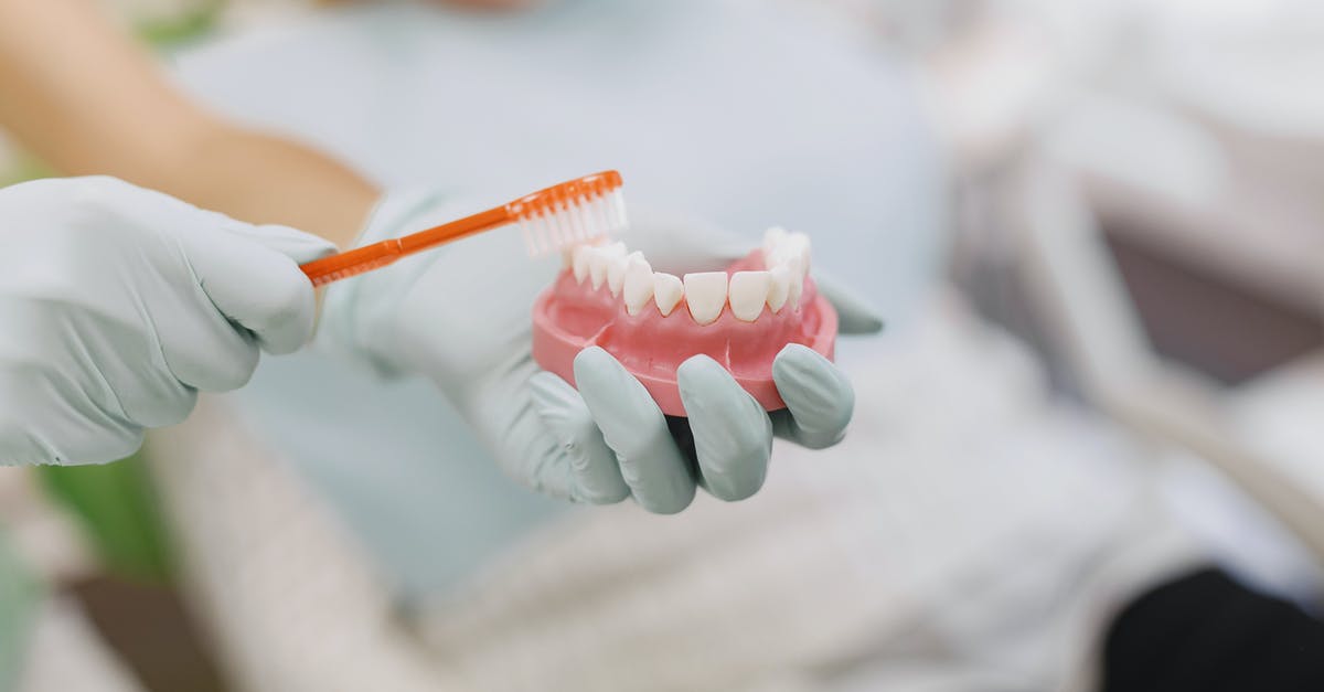How to avoid the rhubarb teeth effect? - Person Holding Orange and White Pen