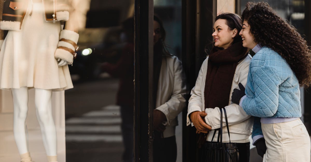 How to best store scallions? - Positive young female friends looking through showcase of boutique How to best store scallions? - Positive young female friends looking through showcase of boutique