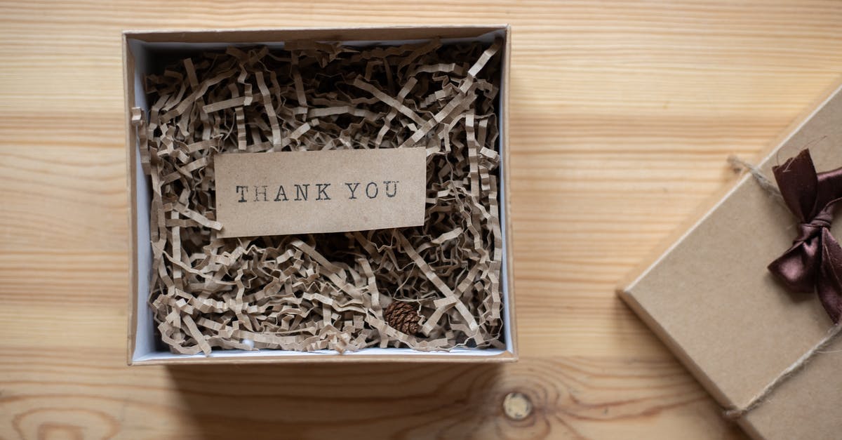 How to brownies from a box/mix with a flaky top? - Top view of opened carton present box with small postcard with Thank You inscription and paper stuffing on wooden table How to brownies from a box/mix with a flaky top? - Top view of opened carton present box with small postcard with Thank You inscription and paper stuffing on wooden table