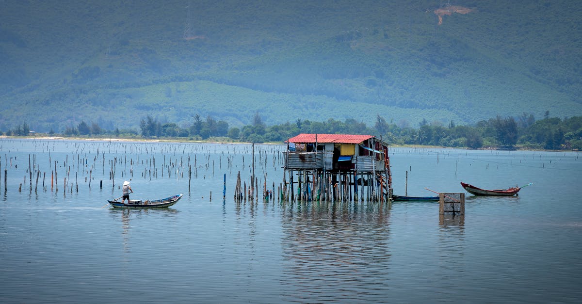 How to catch culture out of yogurt? - Anonymous fisherman catching fish in lake from boat against mount How to catch culture out of yogurt? - Anonymous fisherman catching fish in lake from boat against mount