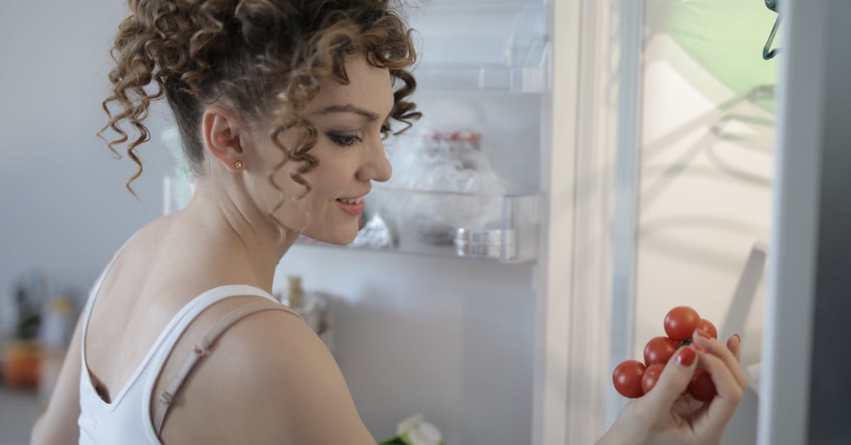 How to choose fresh, ripe (hot) jalapeños? - Side view of content female in casual wear standing in kitchen near opened fridge and picking fruit for breakfast How to choose fresh, ripe (hot) jalapeños? - Side view of content female in casual wear standing in kitchen near opened fridge and picking fruit for breakfast