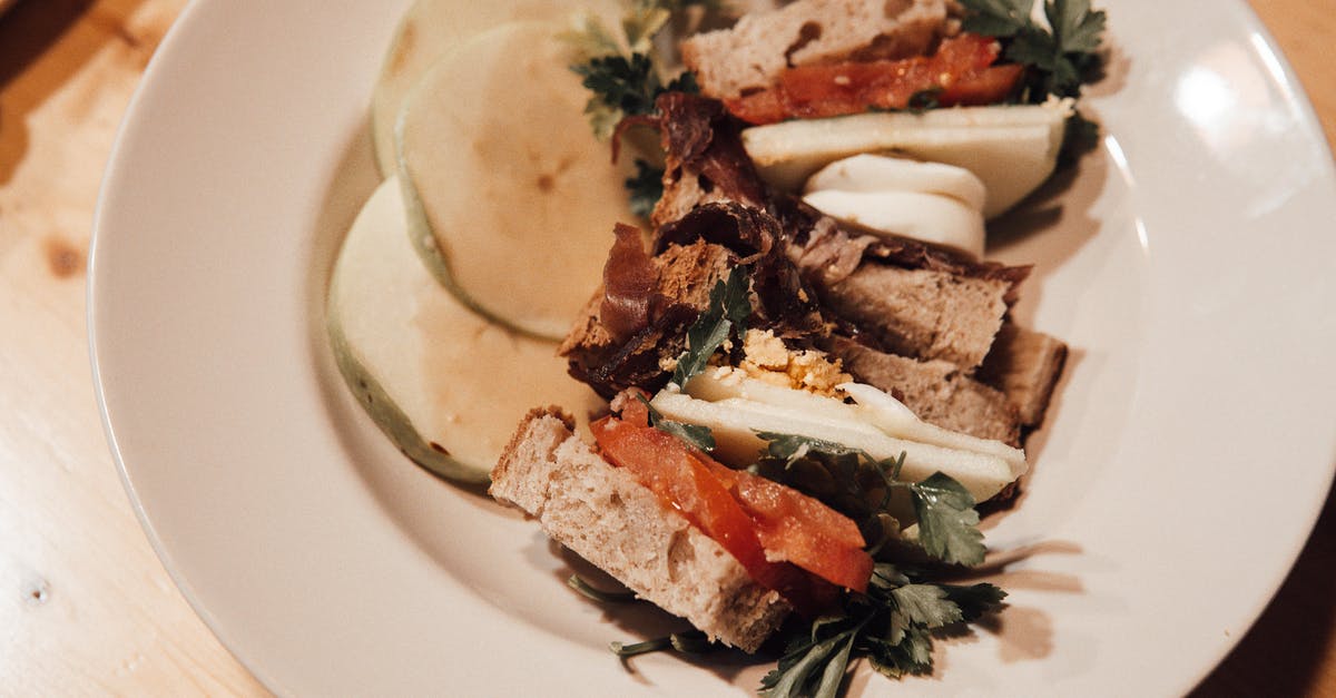 How to cleanly slice hard-boiled eggs? - From above of tasty appetizers of smoked salmon and bread pieces with fresh parsley sprigs on plate How to cleanly slice hard-boiled eggs? - From above of tasty appetizers of smoked salmon and bread pieces with fresh parsley sprigs on plate