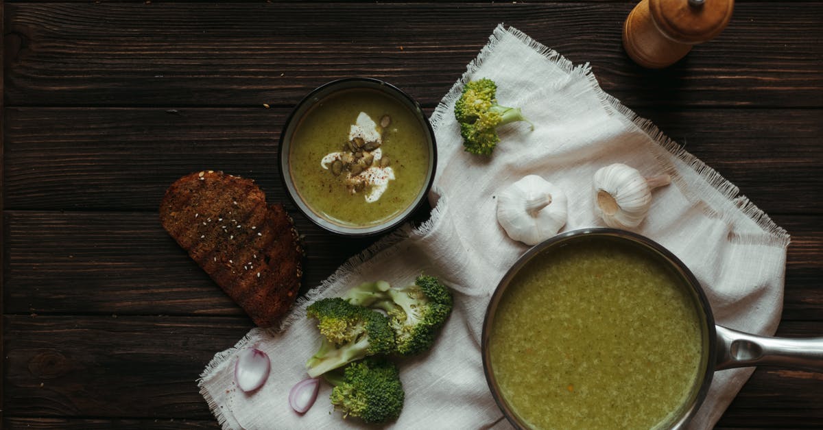 How to combine chocolate and garlic in the same dish? - Top view of saucepan with broccoli puree soup on white napkin with garlic and toasted bread slice How to combine chocolate and garlic in the same dish? - Top view of saucepan with broccoli puree soup on white napkin with garlic and toasted bread slice